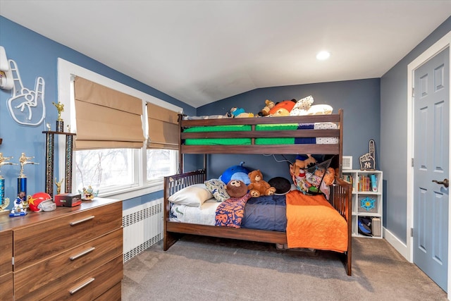 carpeted bedroom with vaulted ceiling and radiator