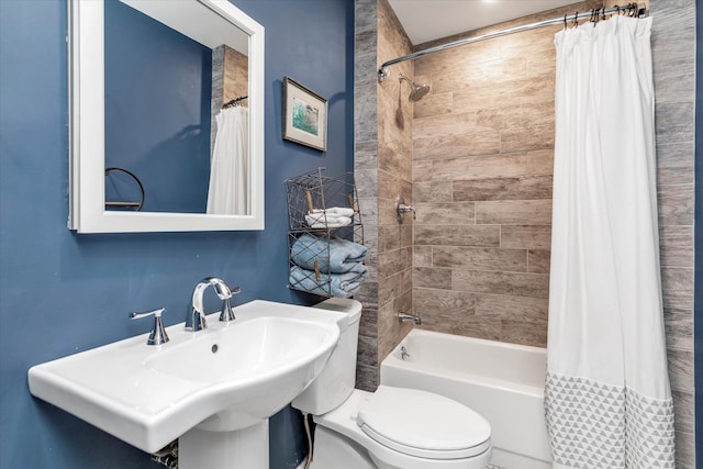 full bathroom with sink, toilet, and shower / bath combo with shower curtain