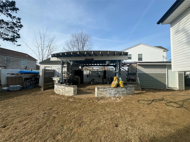 rear view of property featuring a lawn, a patio, and a pergola