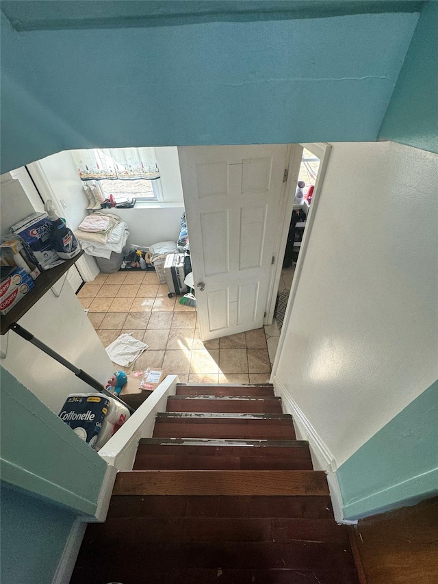 staircase with tile patterned flooring and baseboards