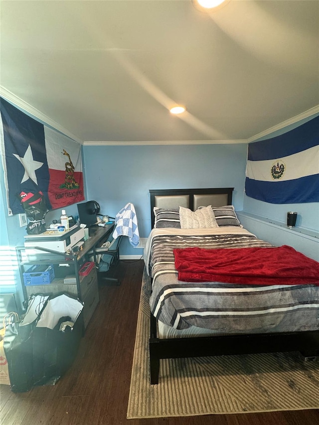 bedroom featuring crown molding and wood finished floors