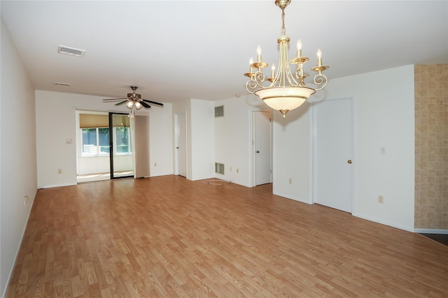 unfurnished room featuring wood-type flooring and ceiling fan with notable chandelier