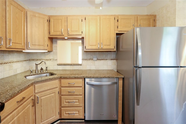 kitchen with sink, light stone counters, tasteful backsplash, light brown cabinets, and stainless steel appliances