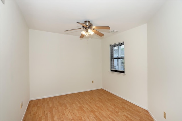 empty room with ceiling fan and light hardwood / wood-style flooring