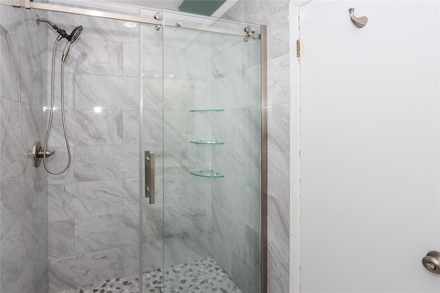 bathroom with a shower with door