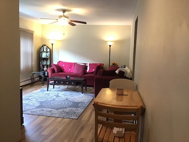 living room featuring hardwood / wood-style flooring, ceiling fan, and baseboard heating