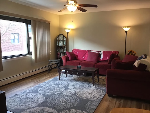 living room with a baseboard radiator, wood-type flooring, and ceiling fan