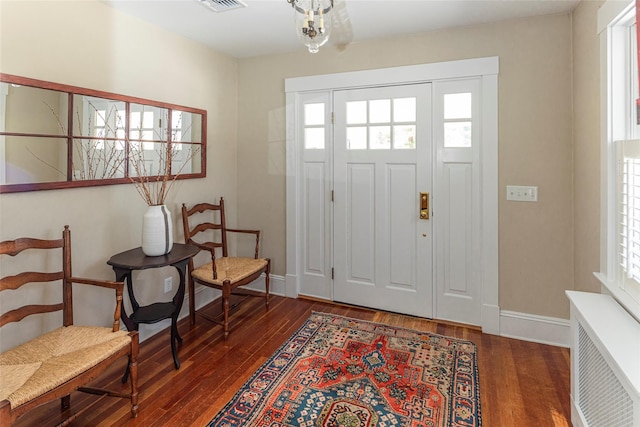 entryway featuring radiator heating unit, dark wood-style flooring, and baseboards