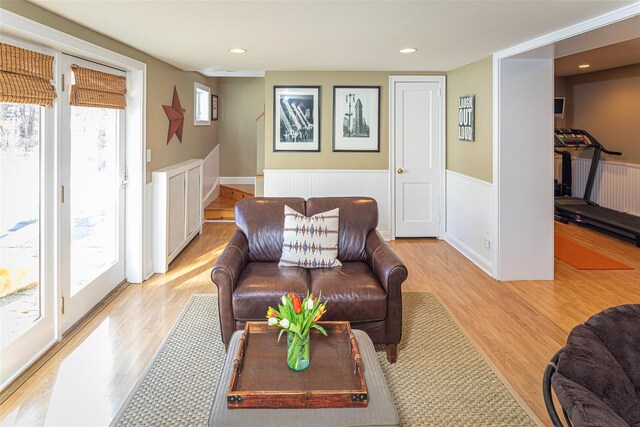 living area with light wood finished floors, wainscoting, and recessed lighting