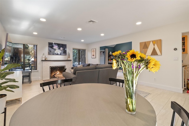 dining area with a brick fireplace