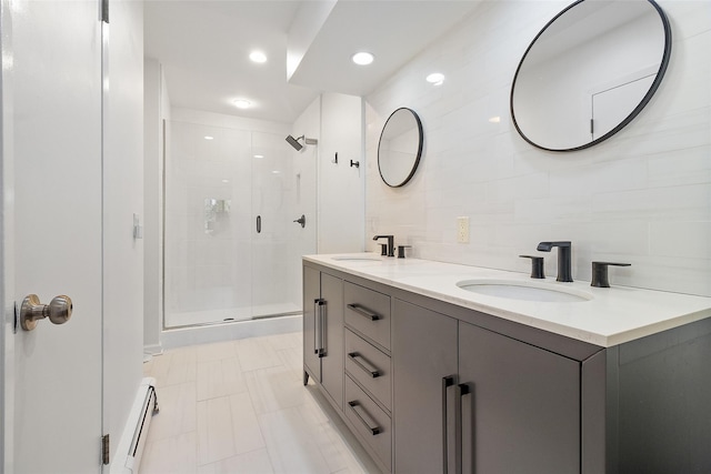 bathroom featuring a baseboard radiator, vanity, and a shower with shower door