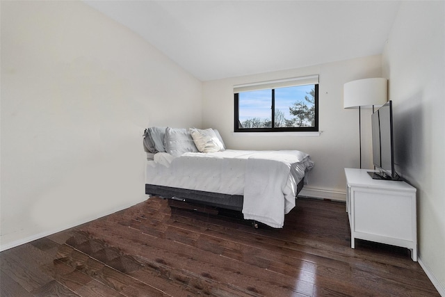 bedroom featuring vaulted ceiling and dark wood-type flooring