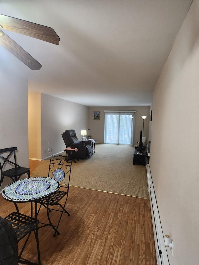 living room featuring a baseboard radiator and hardwood / wood-style floors