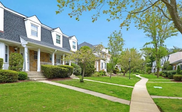 cape cod-style house featuring a porch and a front yard