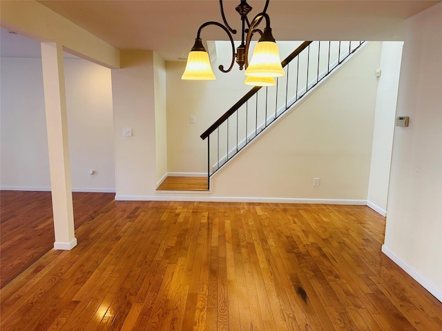 interior space with an inviting chandelier and hardwood / wood-style flooring