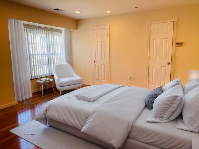 bedroom with dark wood-type flooring