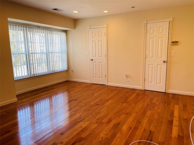 spare room with wood-type flooring