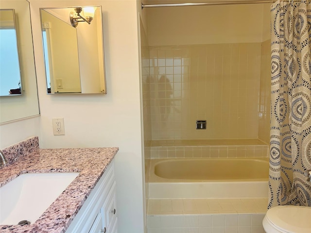 bathroom with vanity, curtained shower, and toilet