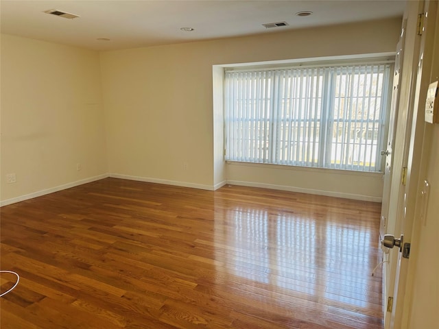 empty room with hardwood / wood-style floors