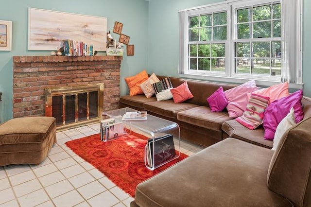 living room with a brick fireplace and light tile patterned floors