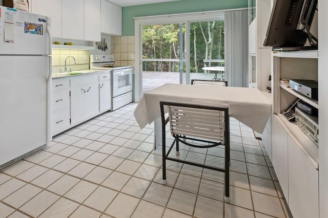 kitchen with white cabinetry, white appliances, sink, and decorative backsplash