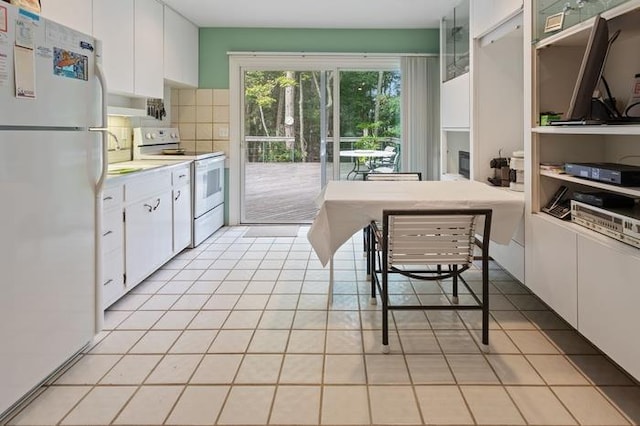 kitchen with sink, white cabinetry, tasteful backsplash, light tile patterned floors, and white appliances