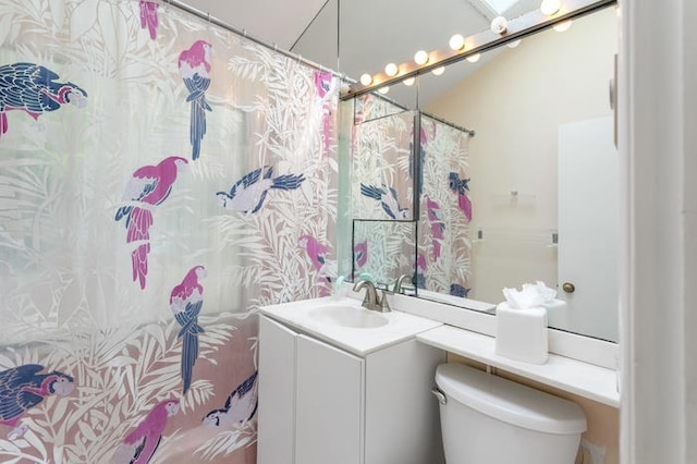 bathroom with vanity, a shower with shower curtain, and toilet