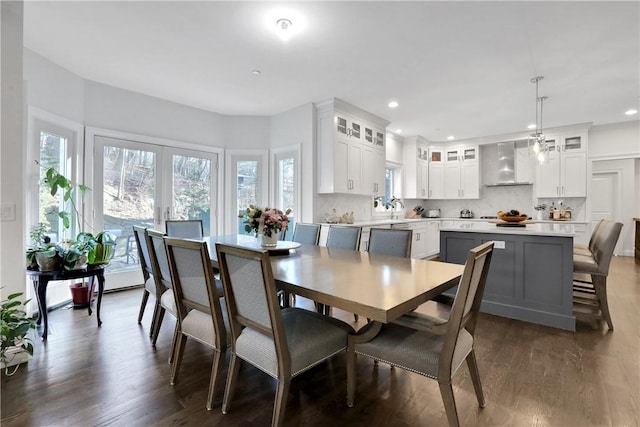 dining area featuring sink, dark wood-type flooring, and french doors