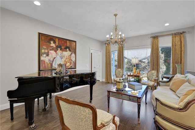 living area with dark wood-type flooring and a notable chandelier