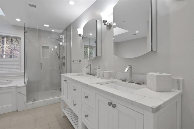 bathroom with vanity, a shower with shower door, and a skylight