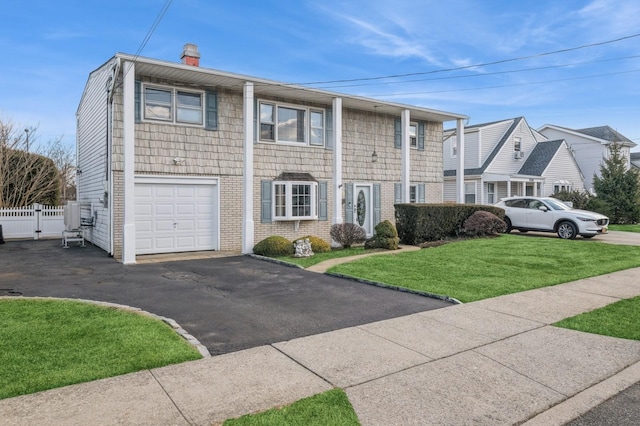 view of front of house with a garage and a front yard