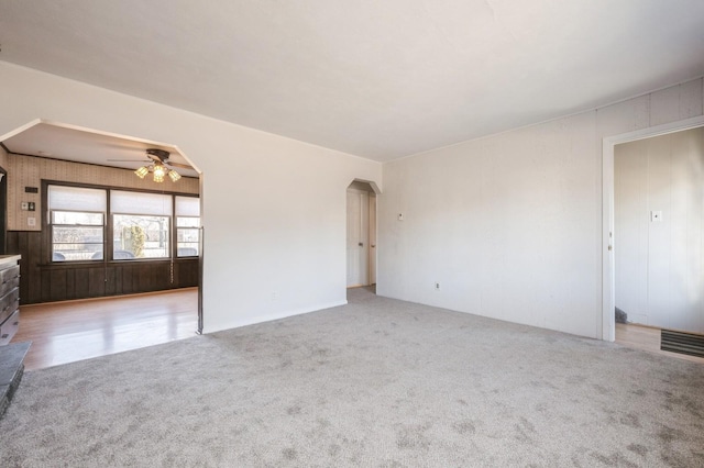 unfurnished living room with ceiling fan and light colored carpet