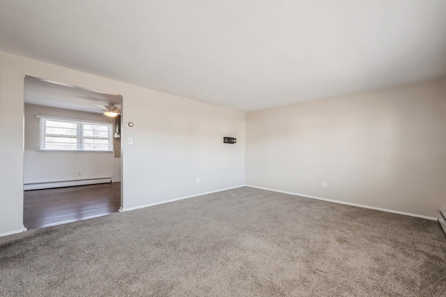 spare room with a baseboard heating unit, carpet floors, and ceiling fan