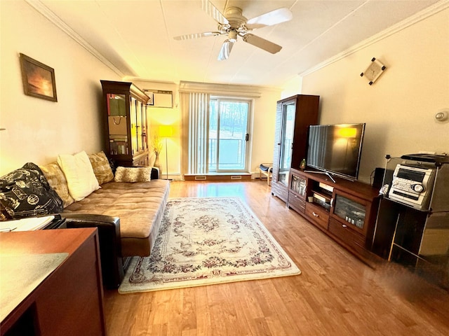 living room with crown molding, ceiling fan, wood-type flooring, and a baseboard heating unit