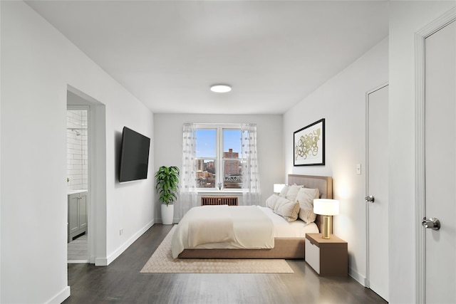 bedroom featuring connected bathroom, radiator, and dark hardwood / wood-style floors