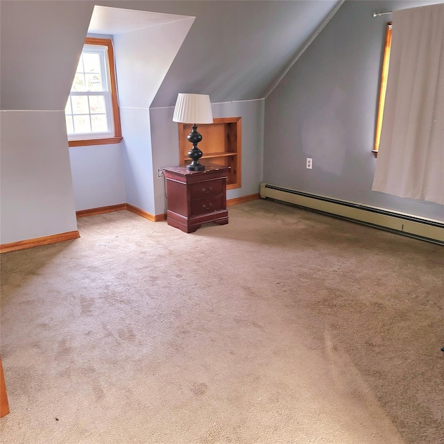 bonus room with light carpet, baseboard heating, built in shelves, and vaulted ceiling