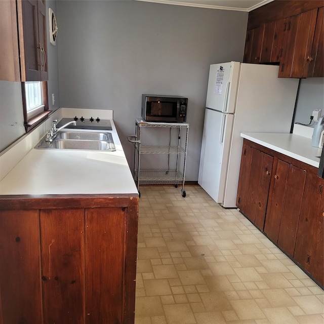 kitchen with sink and white fridge