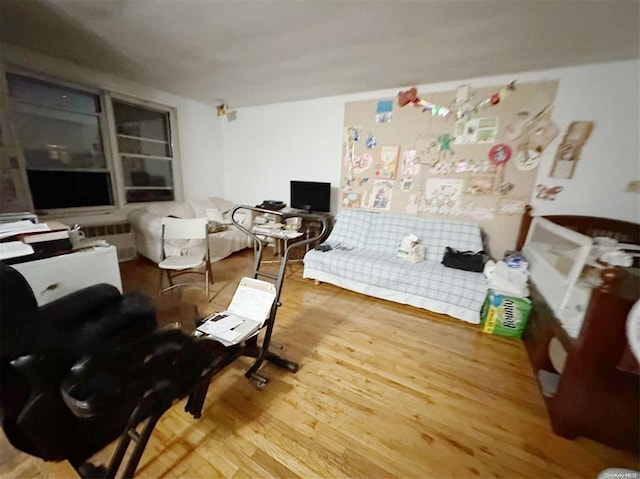 interior space with hardwood / wood-style flooring and radiator