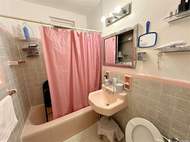 full bathroom featuring sink, shower / bath combo, tile walls, tile patterned flooring, and toilet