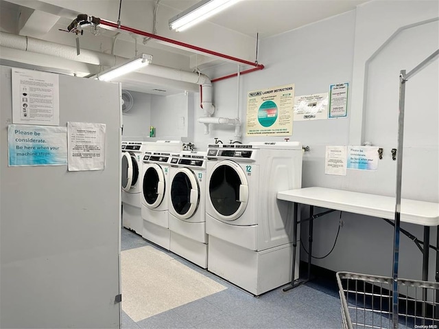 clothes washing area with independent washer and dryer