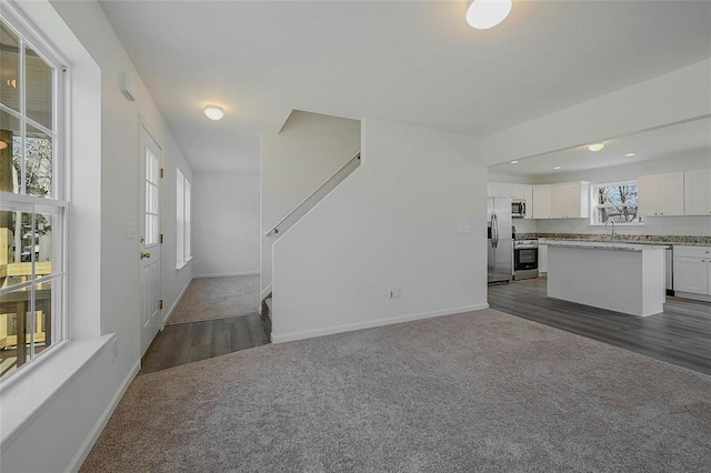 living room with sink and dark carpet