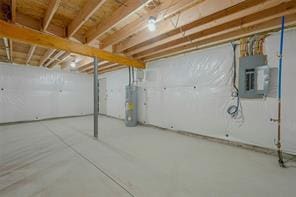 basement featuring water heater and electric panel