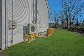 view of property exterior featuring ac unit and a yard