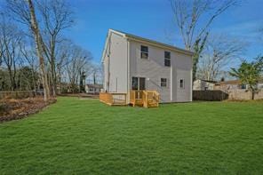 rear view of property with a yard