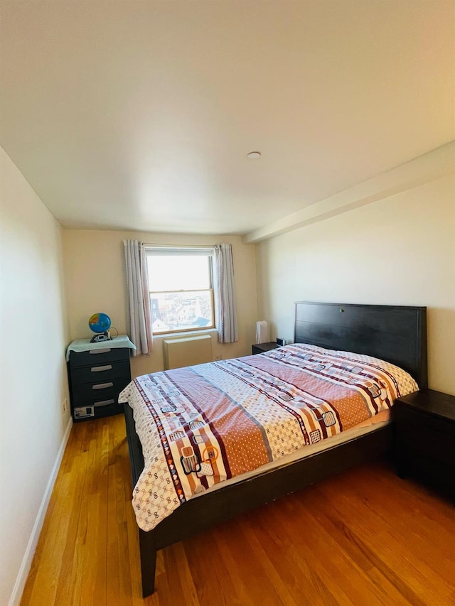 bedroom with hardwood / wood-style flooring