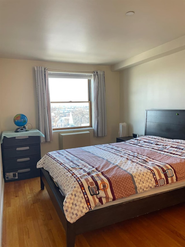 bedroom with hardwood / wood-style floors