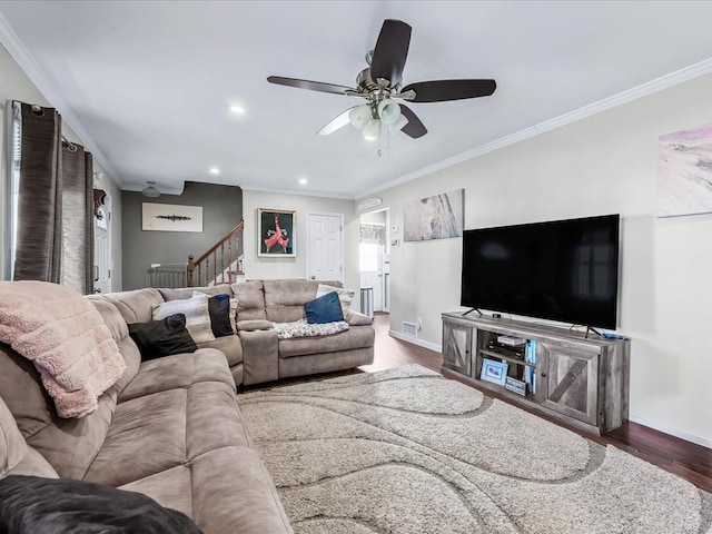 living room featuring crown molding, ceiling fan, and dark wood-type flooring