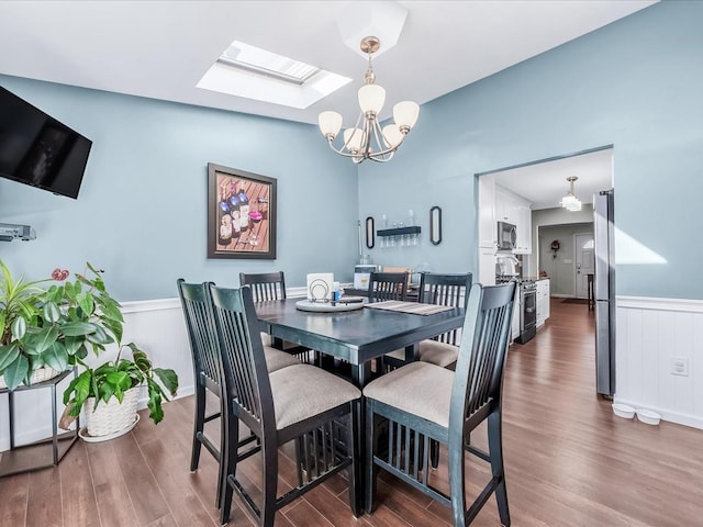 dining area with dark hardwood / wood-style floors and a notable chandelier