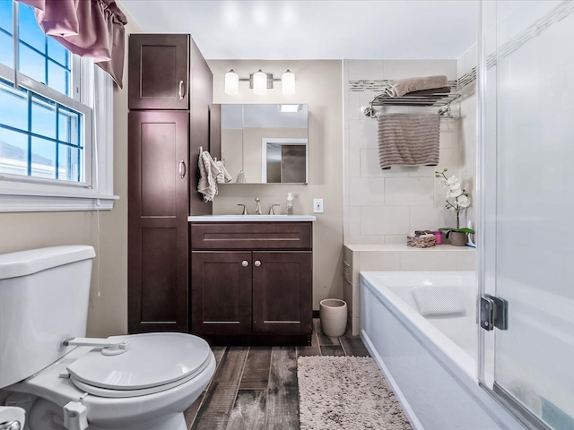 full bathroom with vanity, shower with separate bathtub, and toilet