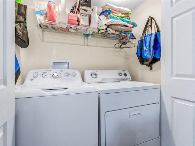 clothes washing area featuring independent washer and dryer